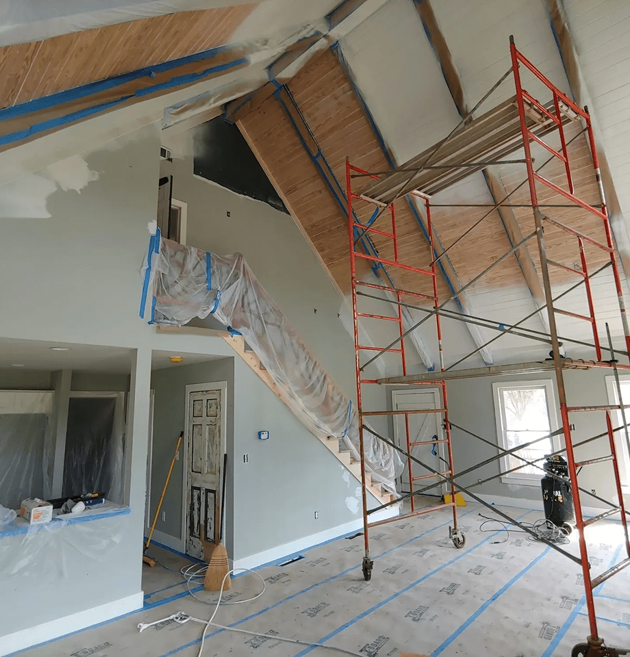 Home interior under renovation with scaffolding.