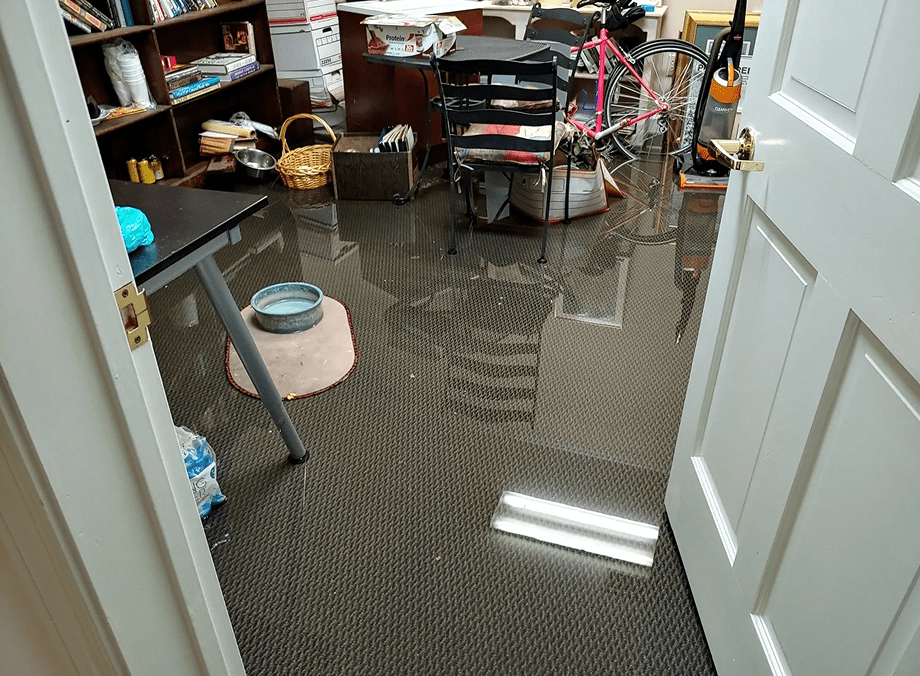Flooded office room with visible water damage.