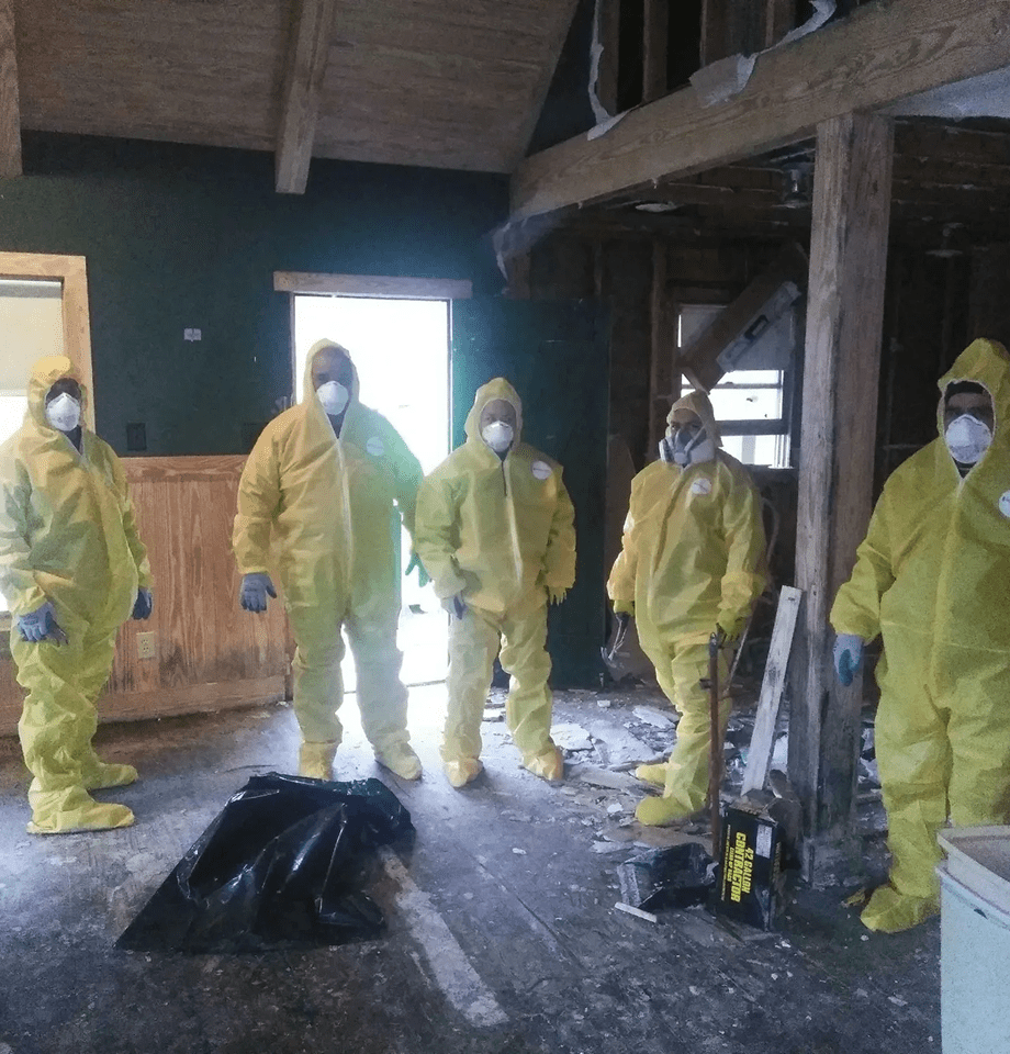 People in hazmat suits inside a building.