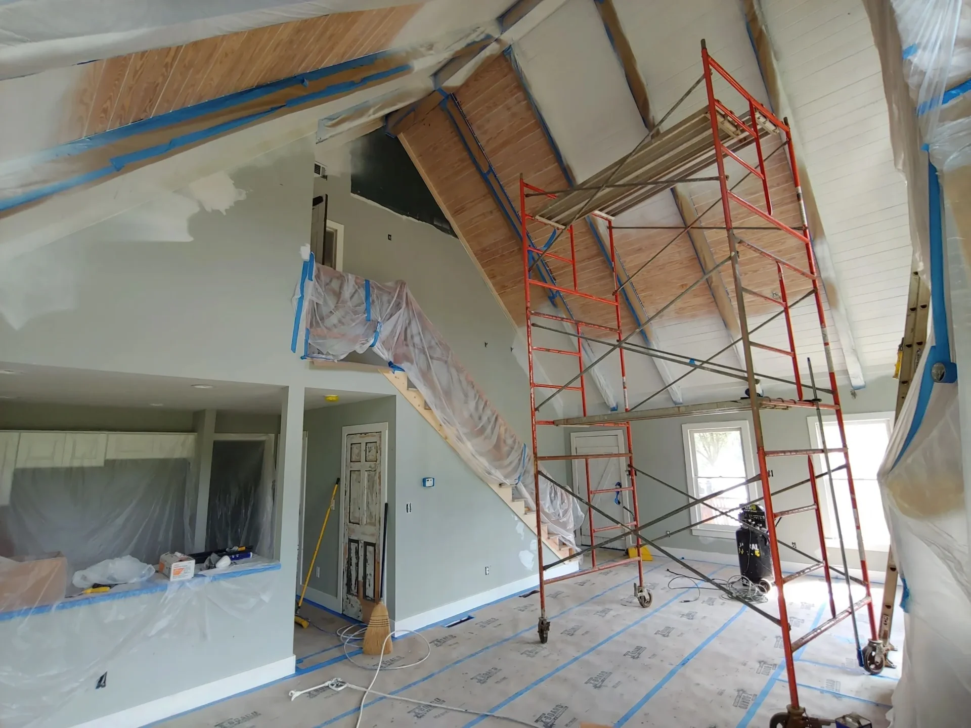 Home interior under renovation with scaffolding.